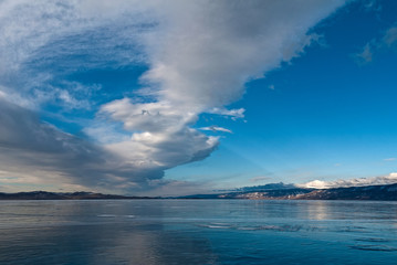Naklejka na ściany i meble clouds over the ice of lake Baikal