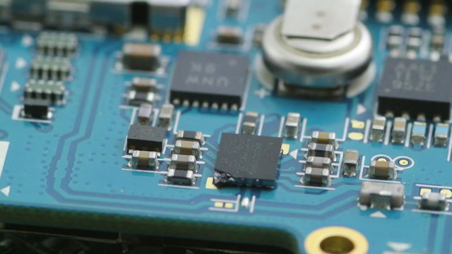 macro video of scrap integrated circuit boards and old electronic chips rotating smoothly