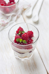 cheesecake with raspberries, mint in glass