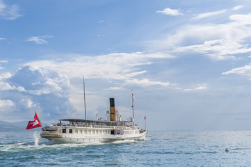 Small steamboat sailing on a lake in Switzerland 
