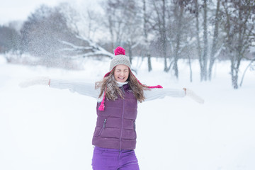 Fototapeta na wymiar Beauty girl playing with snow outdoors