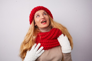 blonde in a red hat and scarf smiling