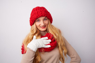 blonde in a red hat and scarf smiling