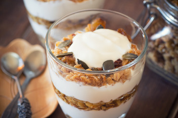 Healthy Breakfast - yogurt with homemade granola on the bright wooden board