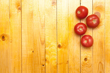 Tomatoes on the wooden background