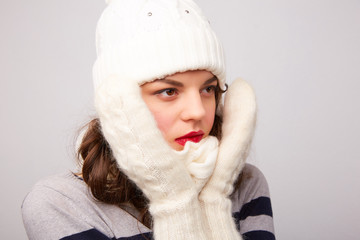 girl in white hat and scarf is frozen