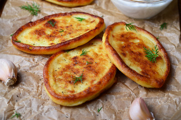 Mashed Potato Fritters with Sour Cream on wooden rustic background
