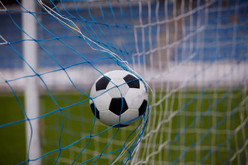 soccer ball in goal net 