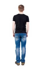 Back view of man in jeans.