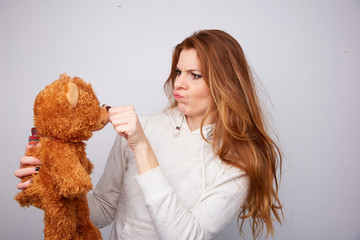 red-haired woman with a teddy bear