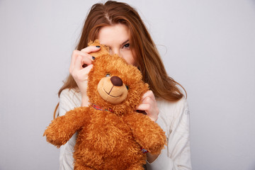 red-haired girl with a teddy bear