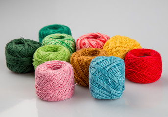 Set of colorful wool yarn balls. Hanks are set out in a pile.