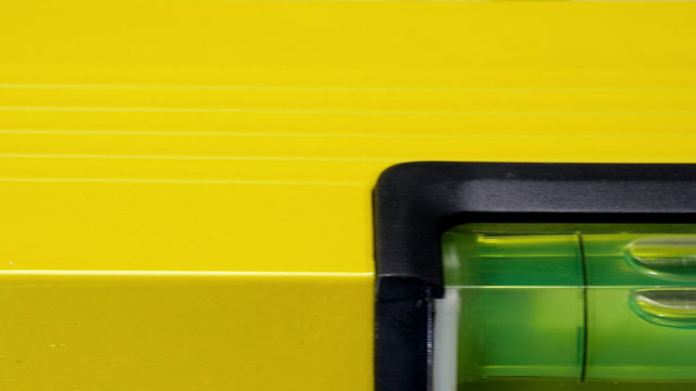 Carpenter's spirit level close up. Measuring the flatness with a spirit level.