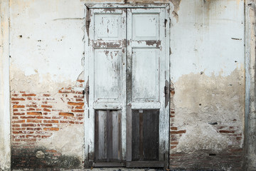 Fototapeta na wymiar Single Wooden Door in Old home Wall