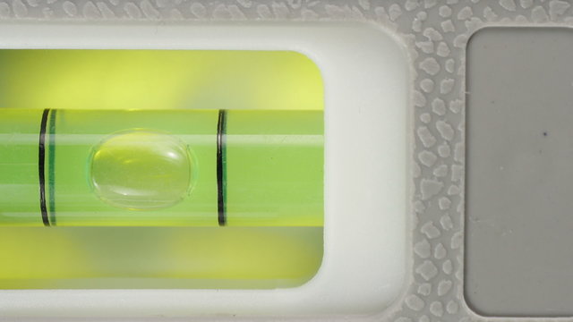 Carpenter's spirit level close up. Measuring the flatness with a spirit level.