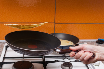 The young woman makes pancakes according to a traditional recipe