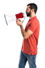 Handsome man shouting by megaphone