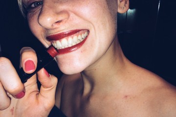 Woman smile with red lips and lipstick at party