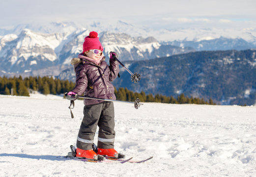  happy little girl skiing downhill