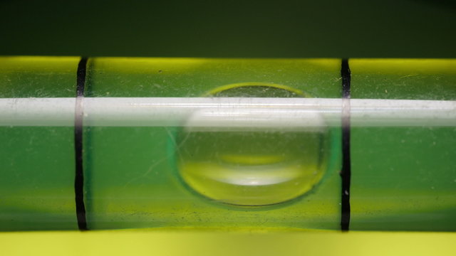 Carpenter's spirit level close up. Measuring the flatness with a spirit level.