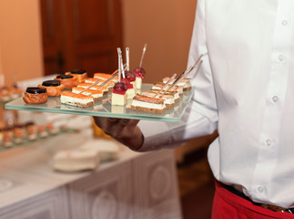 assorted canape dish held by waiter