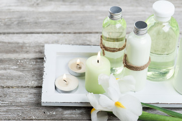 Bath products, candles, wooden background