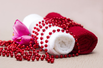 White and red towel around beads and flowers
