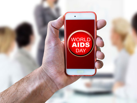 Mobile phone and World Aids Day concept with red ribbon and aids awareness