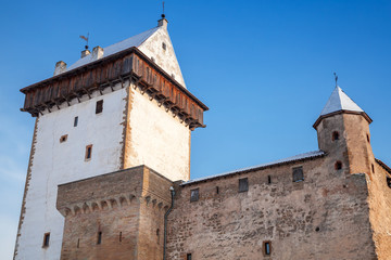 Fototapeta na wymiar Herman castle facade fragment over blue sky. Narva