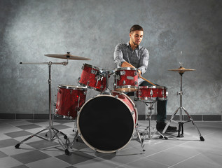 Musician playing the drums in a studio