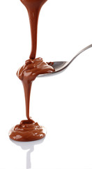 Melted milky brown chocolate pouring from a spoon, isolated on white