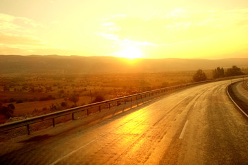 Fototapeta premium Beautiful golden sunrise over the road