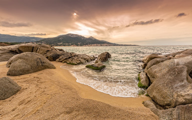 Fototapeta na wymiar Rocks and sand at Algajola beach in Corsica