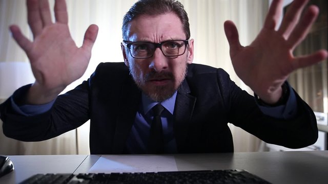 computer problems in an adult male businessman, he yells and screams looking at the monitor  he's got some bad business news