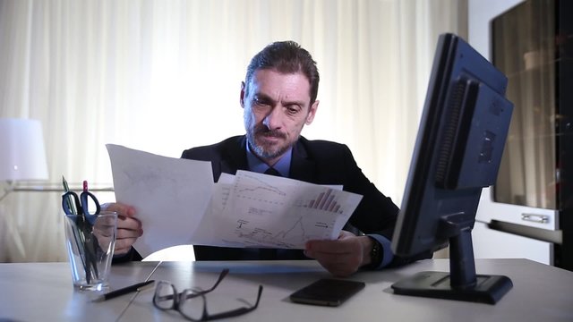boss overwhelmed by too much paperwork in the stress and sad