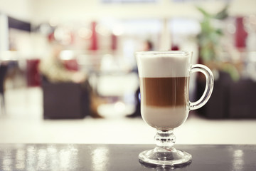 Tasty latte on the table in the cafe, close up