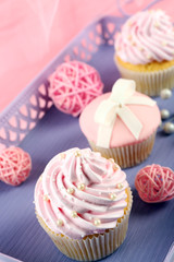 Few tasty cupcakes in basket with decorations, closeup