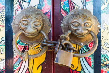 Old Chinese style door with iron chain and mythical wild animal