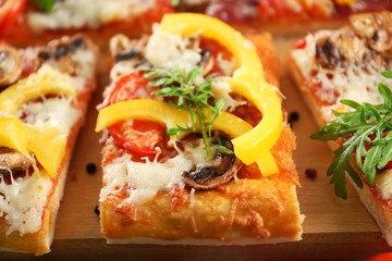 Pieces of delicious pizza on the table, close-up