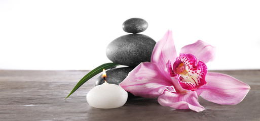 Spa still life with beautiful flower and candlelight on white background