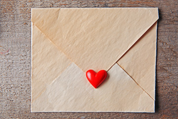 Blank present Valentine envelope on wooden background