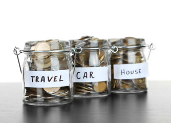 Three jars for different needs full of coins