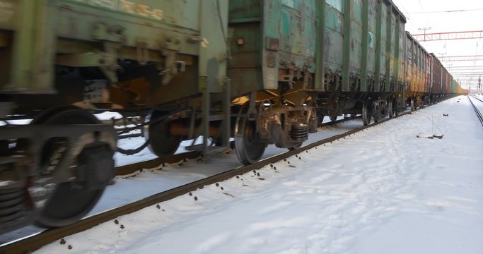 Wagons of Fraight Train Driven Foreward Inscription Abbreviation in Russian VTB Train is Leaving the Station Moving by Railways Winter Station in Konotop