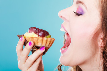 woman face profile open mouth eating cake