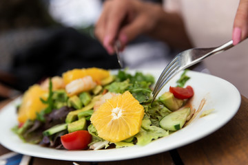 woman is eating a salad