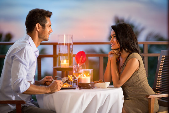 Couple sharing romantic sunset dinner