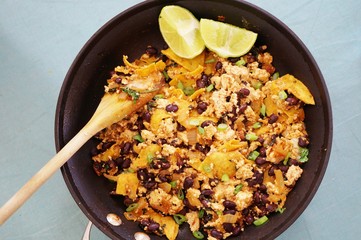 Vegan tofu scramble chilaquiles with beans, scallions and lime