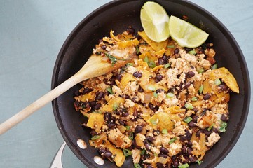 Vegan tofu scramble chilaquiles with beans, scallions and lime - obrazy, fototapety, plakaty