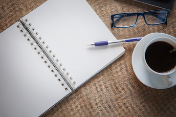 white paper book and coffee on table