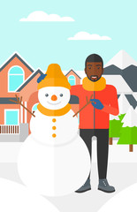 Man posing near snowman.